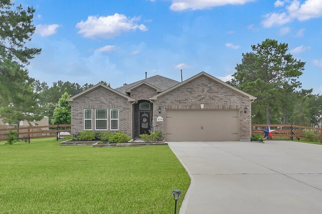 16220 Fayette St, Conroe, TX 77303 - view of front of property with brick siding, concrete driveway, and a garage