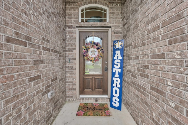 16220 Fayette St, Conroe, TX 77303 - view of exterior entry featuring brick siding