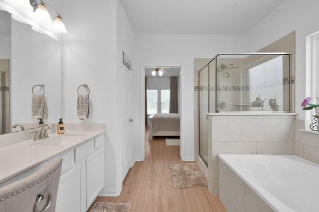 16220 Fayette St, Conroe, TX 77303 - bathroom with a stall shower, wood finished floors, a garden tub, vanity, and ensuite bath