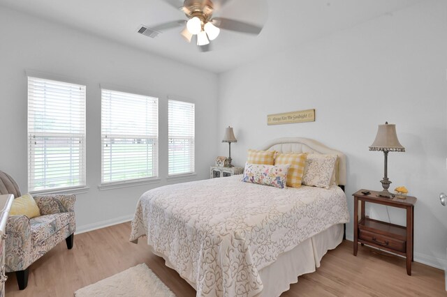 16220 Fayette St, Conroe, TX 77303 - bedroom with light wood-style flooring, baseboards, and ceiling fan