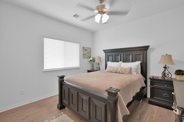 16220 Fayette St, Conroe, TX 77303 - bedroom with light wood-style flooring, baseboards, and a ceiling fan