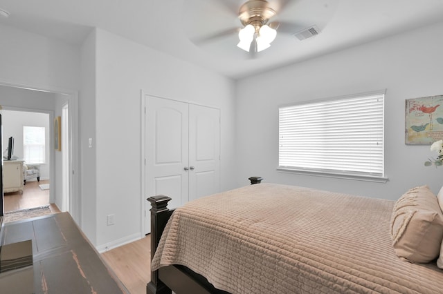16220 Fayette St, Conroe, TX 77303 - bedroom with light wood finished floors, a closet, and a ceiling fan