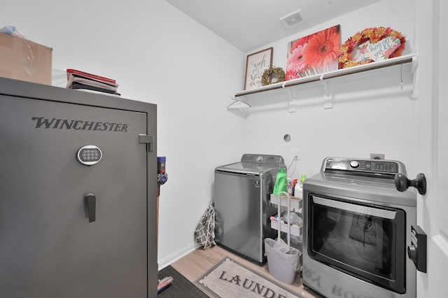 16220 Fayette St, Conroe, TX 77303 - laundry room featuring independent washer and dryer, light wood-style flooring, and baseboards