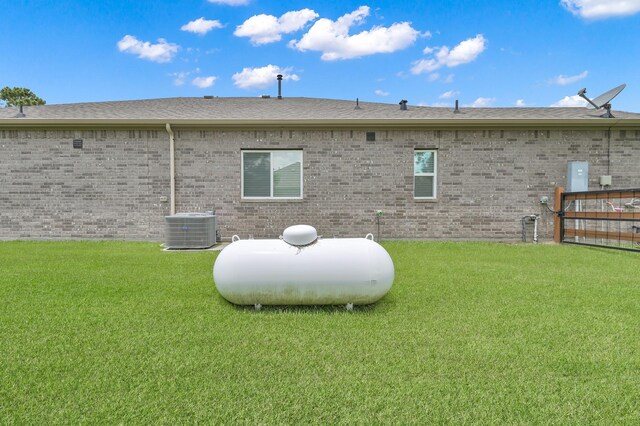 16220 Fayette St, Conroe, TX 77303 - back of house featuring central AC, brick siding, and a shingled roof