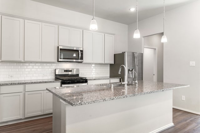 4138 Watson Dr, Rosharon, TX 77583 - kitchen with stainless steel appliances, tasteful backsplash, a sink, dark wood finished floors, and a kitchen island with sink