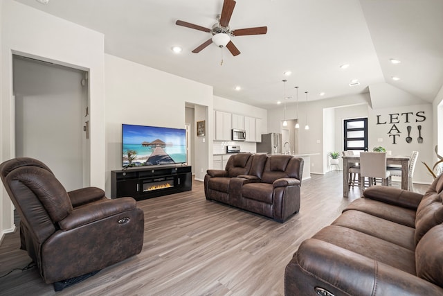 4138 Watson Dr, Rosharon, TX 77583 - living area with ceiling fan, light wood-type flooring, baseboards, a glass covered fireplace, and recessed lighting
