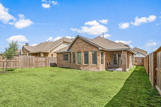 4138 Watson Dr, Rosharon, TX 77583 - back of property with brick siding, roof with shingles, and a patio area
