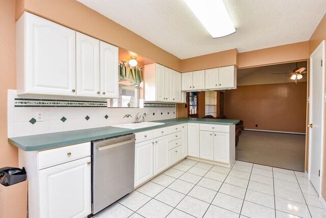 3310 Park Haven Ln, Deer Park, TX 77536 - kitchen featuring stainless steel dishwasher, tasteful backsplash, white cabinetry, light tile patterned floors, and a textured ceiling