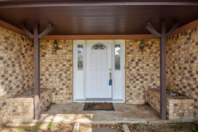 3310 Park Haven Ln, Deer Park, TX 77536 - view of exterior entry featuring brick siding and a porch