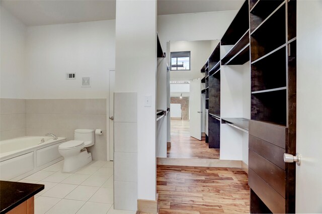 1601 W Webster St Unit 9, Houston, TX 77019 - full bathroom featuring toilet, a garden tub, wood finished floors, and vanity