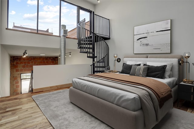 1601 W Webster St Unit 9, Houston, TX 77019 - bedroom with a high ceiling and wood finished floors