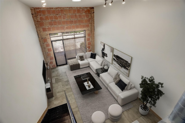 1601 W Webster St Unit 9, Houston, TX 77019 - living area featuring brick wall and track lighting