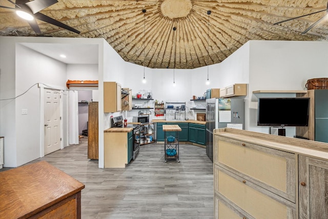 8354 Hannay Rd, Pattison, TX 77423 - kitchen featuring appliances with stainless steel finishes, a ceiling fan, light wood-type flooring, open shelves, and blue cabinetry