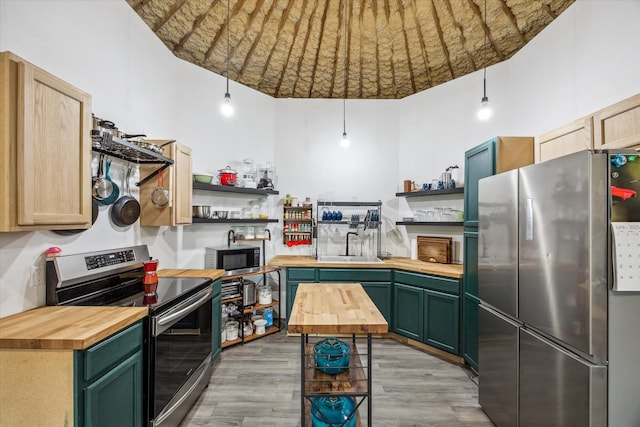 8354 Hannay Rd, Pattison, TX 77423 - kitchen with stainless steel appliances, open shelves, wooden counters, and green cabinetry