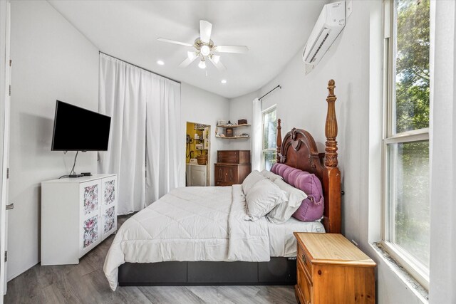 8354 Hannay Rd, Pattison, TX 77423 - bedroom featuring a wall mounted air conditioner, multiple windows, wood finished floors, and ceiling fan