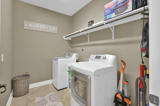 116 Owen Ridge Dr, Conroe, TX 77384 - washroom with washer and clothes dryer, baseboards, and light tile patterned floors