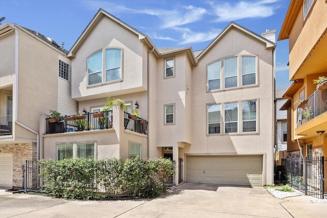 1310 Cohn St, Houston, TX 77007 - townhome / multi-family property with stucco siding, a garage, and concrete driveway