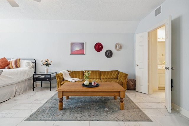 1310 Cohn St, Houston, TX 77007 - living room featuring light marble finish flooring, lofted ceiling, a ceiling fan, and a textured ceiling