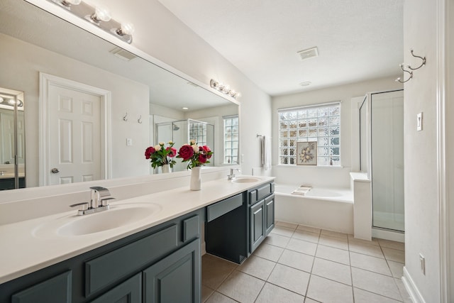 1310 Cohn St, Houston, TX 77007 - bathroom with a garden tub, double vanity, a shower stall, and tile patterned floors