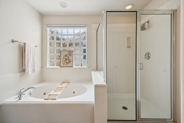 1310 Cohn St, Houston, TX 77007 - bathroom featuring a shower stall, a jetted tub, and plenty of natural light