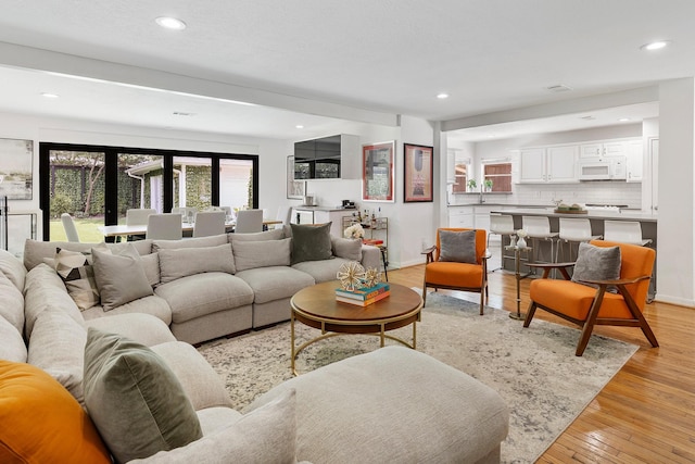 3923 W Main St, Houston, TX 77027 - living room featuring recessed lighting, light wood-style flooring, and baseboards