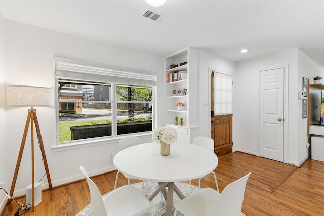 3923 W Main St, Houston, TX 77027 - dining room featuring baseboards and light wood-style floors