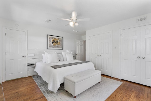 3923 W Main St, Houston, TX 77027 - bedroom featuring multiple closets, wood finished floors, and ceiling fan