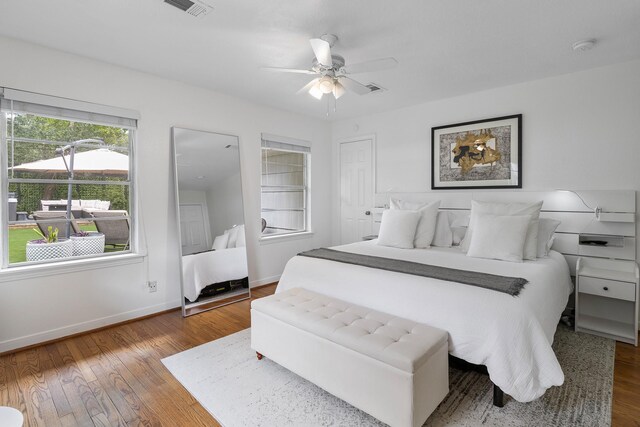 3923 W Main St, Houston, TX 77027 - bedroom with baseboards, wood finished floors, and ceiling fan
