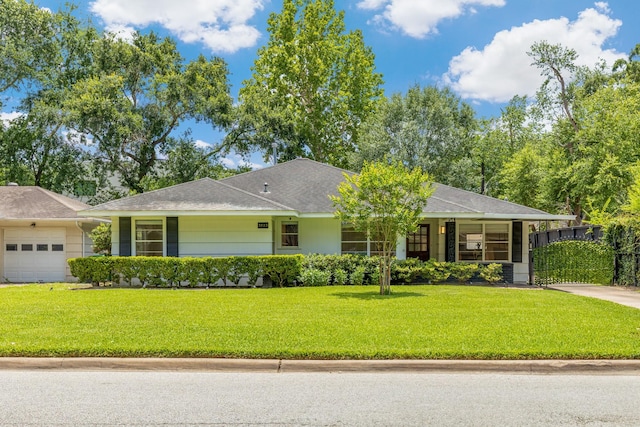 3923 W Main St, Houston, TX 77027 - ranch-style home with an attached garage and a front lawn