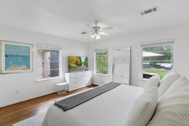 3923 W Main St, Houston, TX 77027 - bedroom with wood finished floors, baseboards, and a ceiling fan