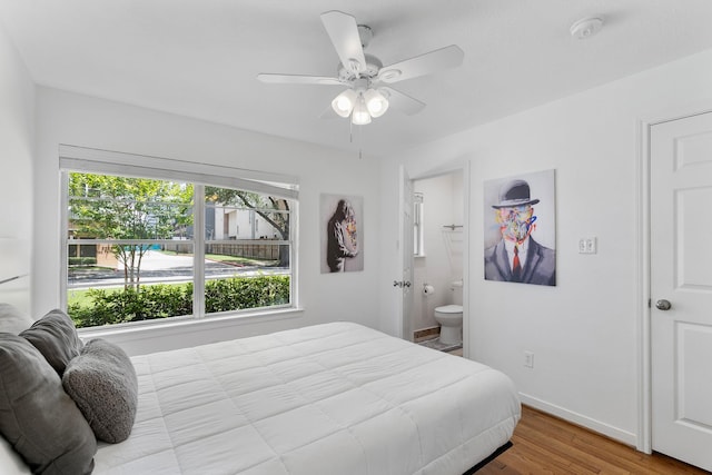 3923 W Main St, Houston, TX 77027 - bedroom with multiple windows, wood finished floors, baseboards, and ensuite bath