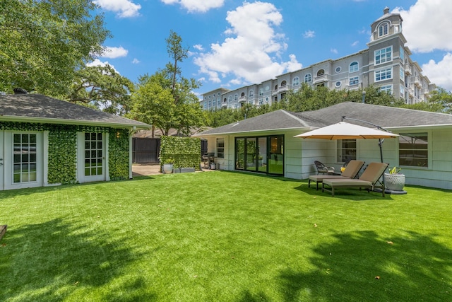 3923 W Main St, Houston, TX 77027 - rear view of house featuring a lawn and roof with shingles