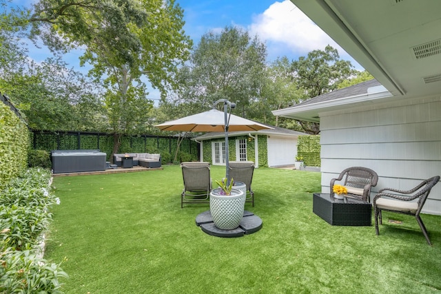 3923 W Main St, Houston, TX 77027 - view of yard with outdoor lounge area, a hot tub, and an outbuilding