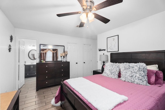 13031 Crystal Cove Dr, Houston, TX 77044 - bedroom with light wood-style floors, a ceiling fan, and ensuite bath
