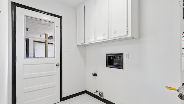 14407 Chevy Chase Dr, Houston, TX 77077 - washroom featuring light marble finish floors, cabinet space, baseboards, hookup for a gas dryer, and hookup for an electric dryer