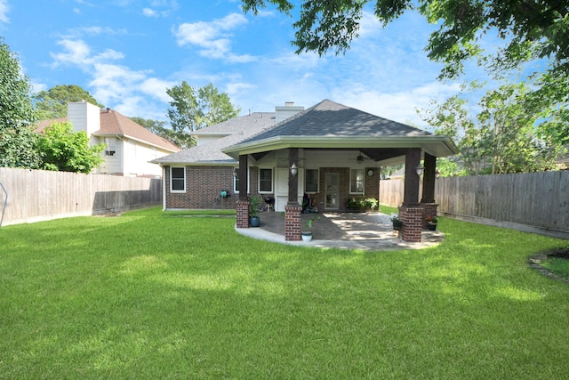 23227 Diamond Knoll Ct, Katy, TX 77494 - rear view of house with brick siding, roof with shingles, a ceiling fan, a fenced backyard, and a patio