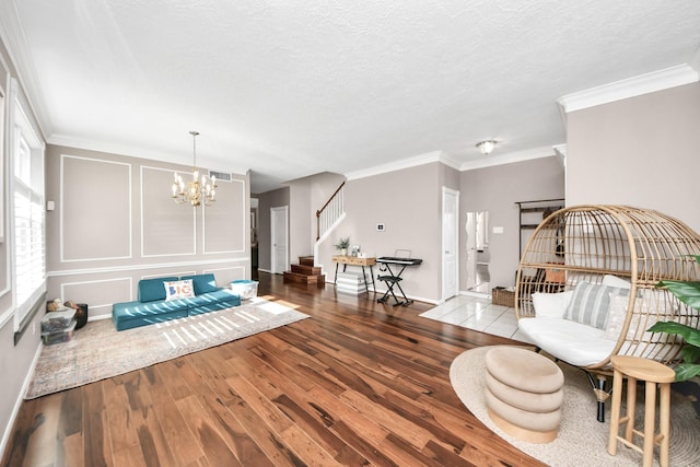 23227 Diamond Knoll Ct, Katy, TX 77494 - living area with stairs, hardwood / wood-style floors, a chandelier, crown molding, and a textured ceiling