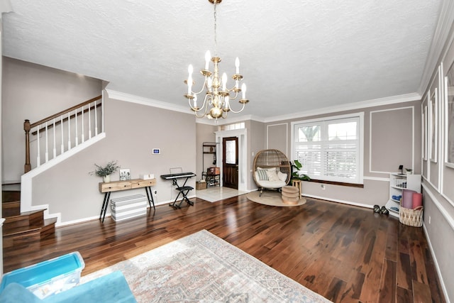 23227 Diamond Knoll Ct, Katy, TX 77494 - living area featuring stairway, wood finished floors, a chandelier, ornamental molding, and a textured ceiling