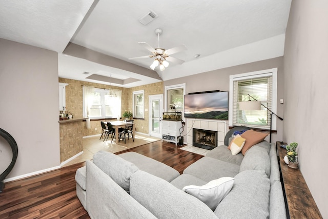 23227 Diamond Knoll Ct, Katy, TX 77494 - living room featuring wood finished floors, ceiling fan, and a fireplace