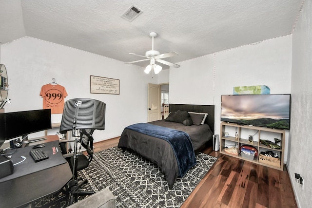 23227 Diamond Knoll Ct, Katy, TX 77494 - bedroom featuring wood finished floors, an office area, a textured ceiling, and a ceiling fan