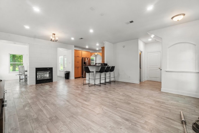 4313 Windswept Dr, Montgomery, TX 77356 - living area featuring light wood finished floors, recessed lighting, and a large fireplace