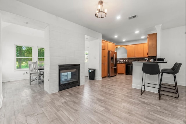 4313 Windswept Dr, Montgomery, TX 77356 - kitchen featuring stainless steel fridge, dishwasher, dark countertops, a peninsula, and decorative backsplash