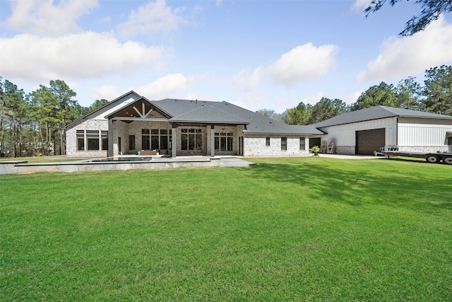 11305 Prince Phillip Ct, Montgomery, TX 77316 - rear view of house with a yard, brick siding, a garage, a patio, and an outbuilding