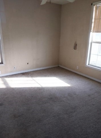 1311 Lamar Ave, Big Spring, TX 79720 - carpeted spare room with baseboards and ceiling fan