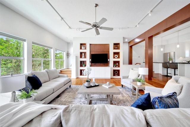 2223 Taft St, Houston, TX 77006 - living room with track lighting, wood finished floors, and ceiling fan