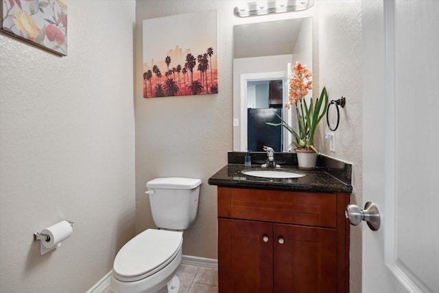 5523 Abundant Life Ln, Houston, TX 77048 - bathroom with toilet, vanity, a textured wall, tile patterned flooring, and baseboards