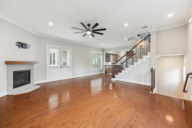 1512 Thompson St Unit 3, Houston, TX 77007 - unfurnished living room with ceiling fan, a fireplace, crown molding, wood finished floors, and stairs