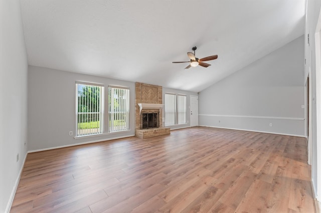 15914 Alta Mesa Dr, Houston, TX 77083 - unfurnished living room featuring a ceiling fan, light wood-type flooring, lofted ceiling, a brick fireplace, and baseboards