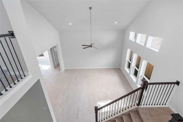 2008 Sugarberry Gully Ln, Conroe, TX 77301 - staircase featuring high vaulted ceiling, wood finished floors, baseboards, a ceiling fan, and recessed lighting