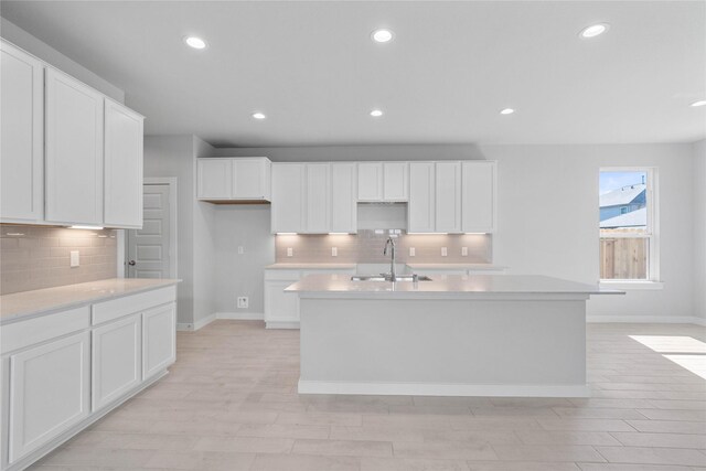2008 Sugarberry Gully Ln, Conroe, TX 77301 - kitchen with a sink, a center island with sink, tasteful backsplash, baseboards, and recessed lighting